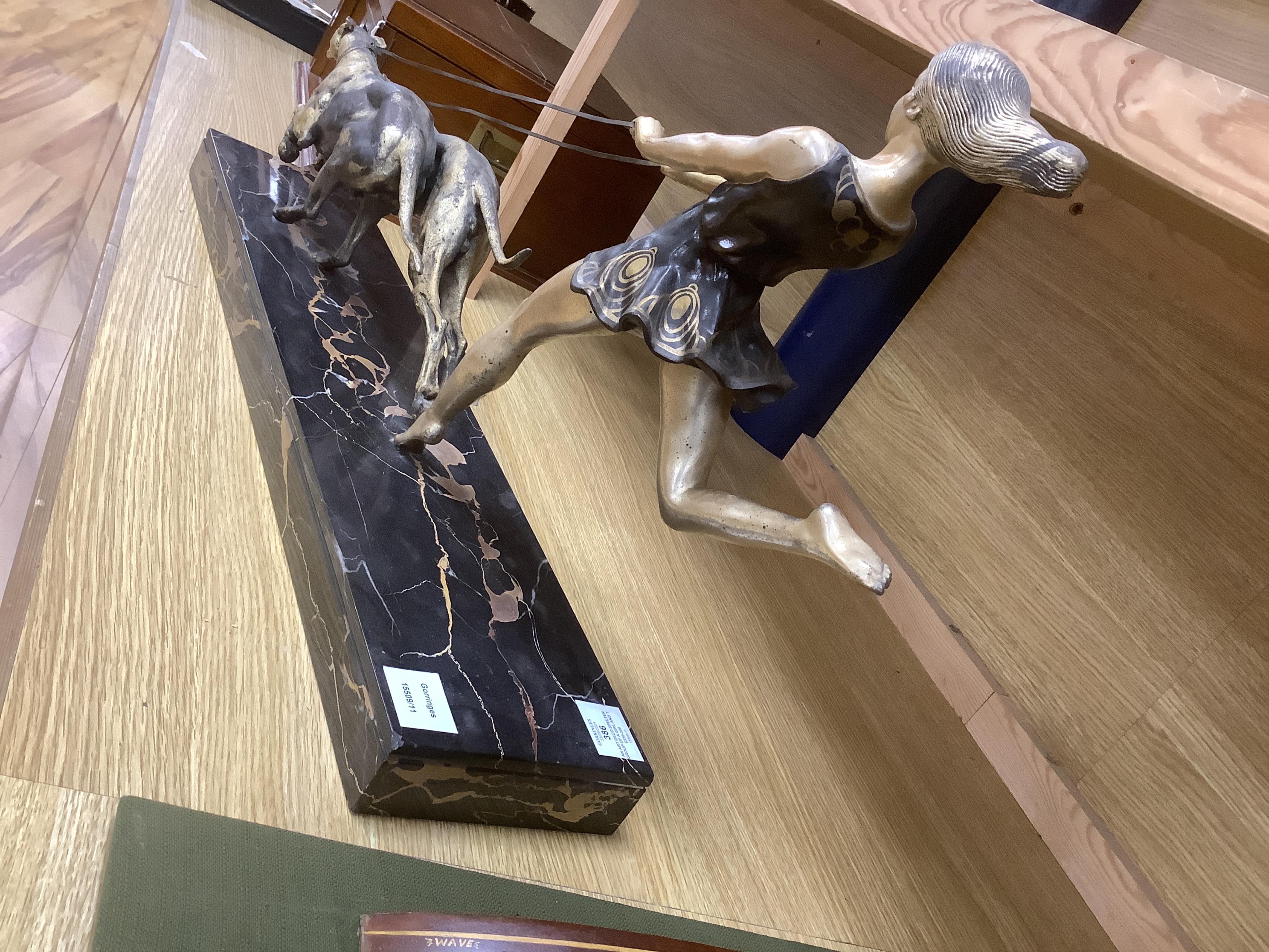 An Art Deco spelter group of a girl and two dogs, signed Geo. Maxim, 77.5cm long. Condition - poor